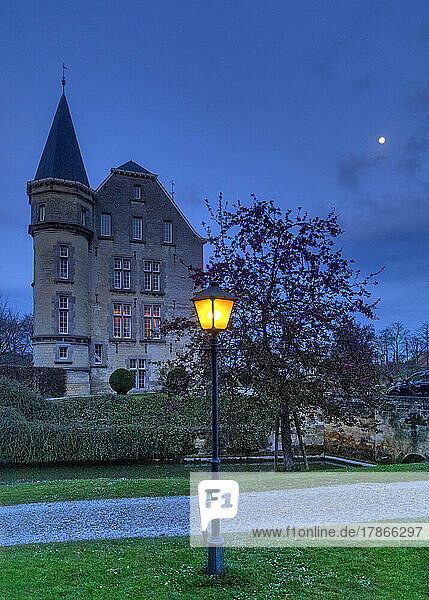The illuminated moated castle Schaloen in Valkenburg aan de Geul at blue hour,  Holland,  Netherlands,  Europe.