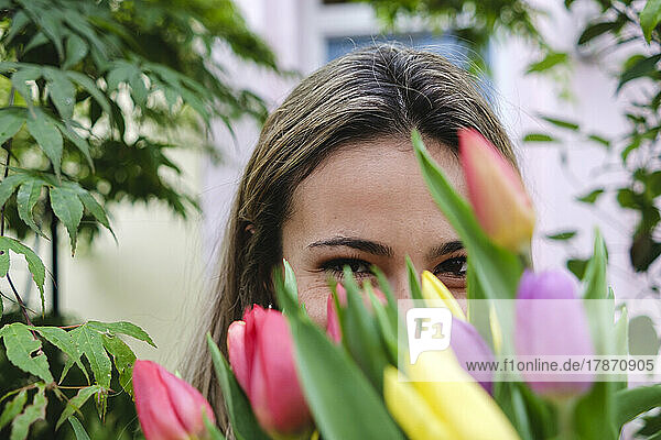 Young woman with fresh tulip flowers