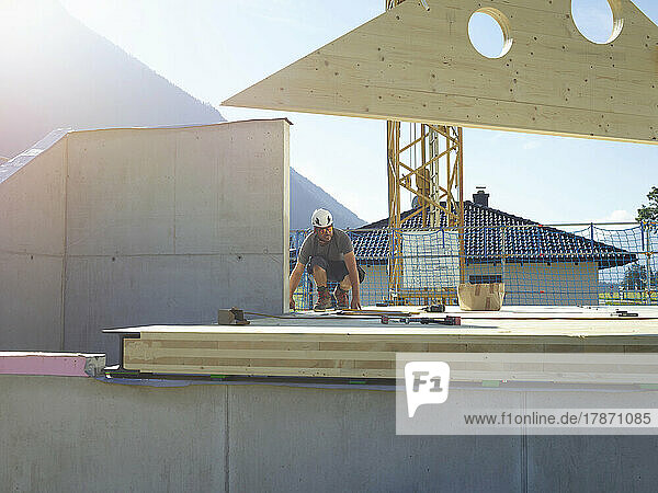 Craftsperson working on rooftop at construction site