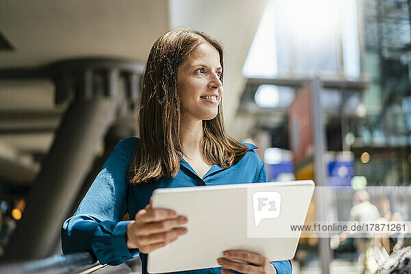 Thoughtful businesswoman with tablet PC in office