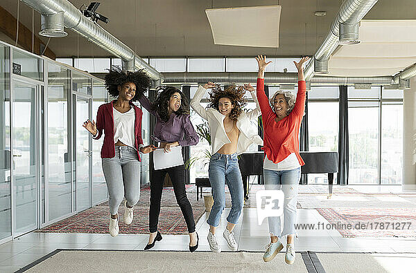 Happy businesswomen jumping in office