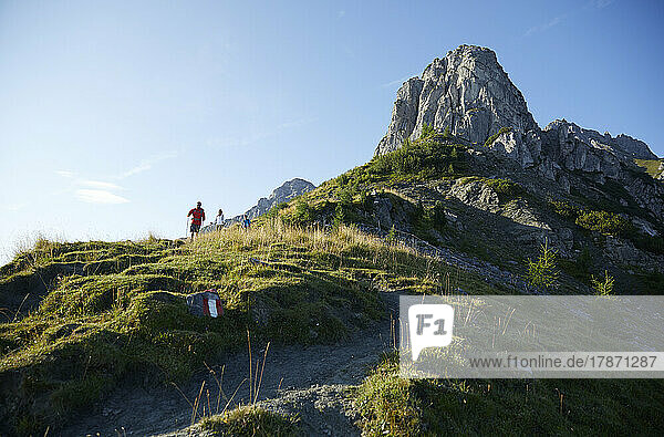 Hikers descending from mountain on sunny day  Mutters  Tyrol  Austria
