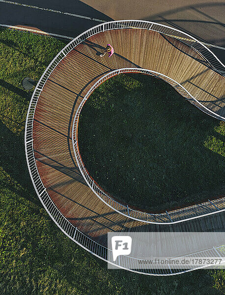 Russia  Aerial view of woman walking along winding boardwalk