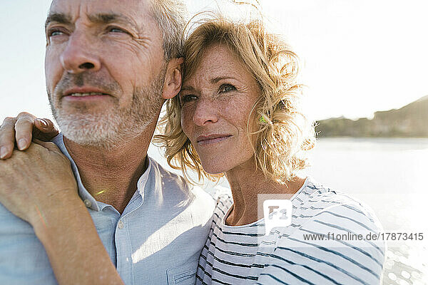 Happy blond woman with man at beach
