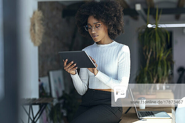 Young businesswoman using tablet PC at office