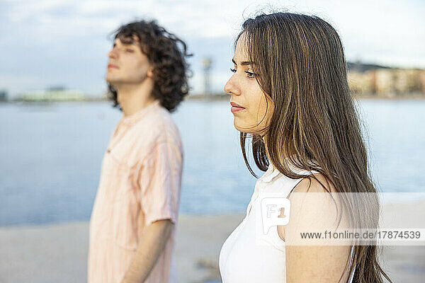 Woman with long brown hair standing by boyfriend
