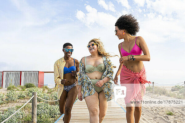 Carefree multiracial women having fun at beach