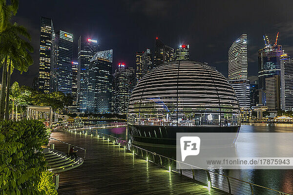 Singapore  Coastal promenade at night with Apple Marina Bay Sands and skyscrapers in background