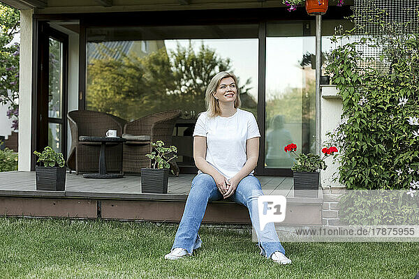 Smiling mature woman sitting on porch