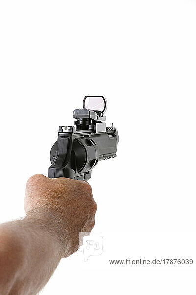 Man shooting with revolver against white background