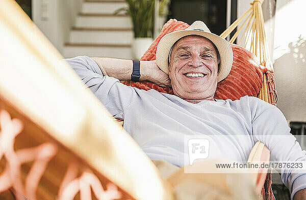 Happy man relaxing in hammock