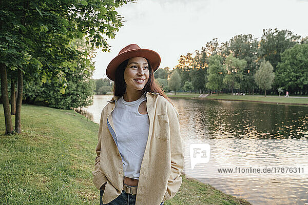 Contemplative woman in hat at park