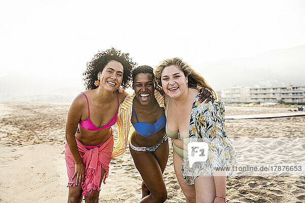 Cheerful women having fun together at beach