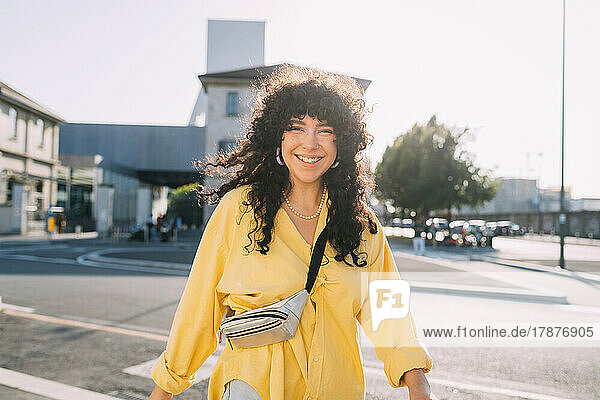 Happy woman walking on street in city