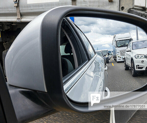 Traffic jam reflecting in side-view mirror