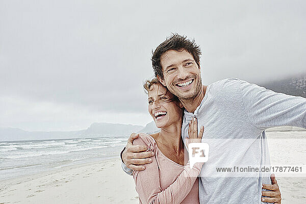 Affecionate couple embracing on the beach