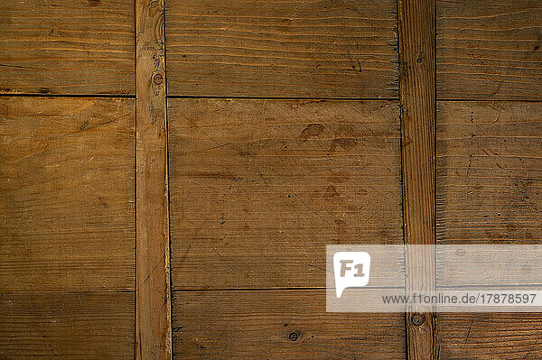 Close-up of worn antique cutting board with cross support wood slats