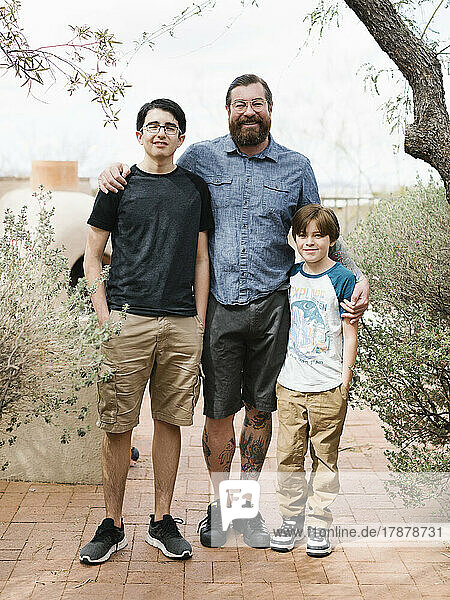 Portrait of father with two sons (8-9  14-15)