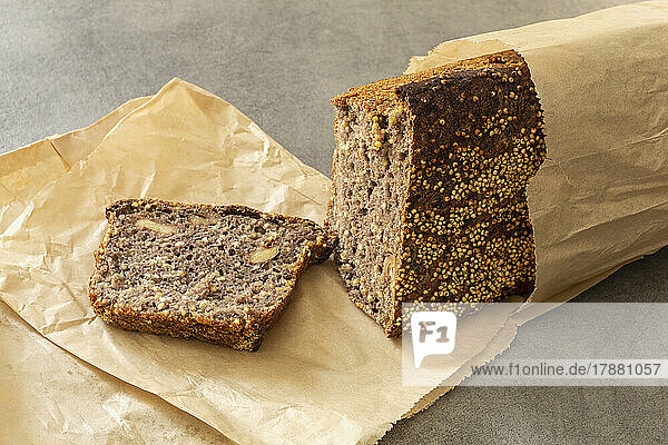 Still life sliced rustic rye bread loaf in parchment paper