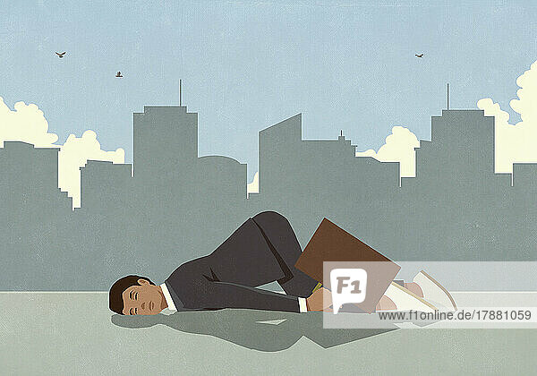 Exhausted businessman sleeping on city sidewalk