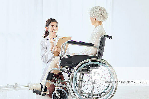 Japanese senior woman on a wheelchair and nurse