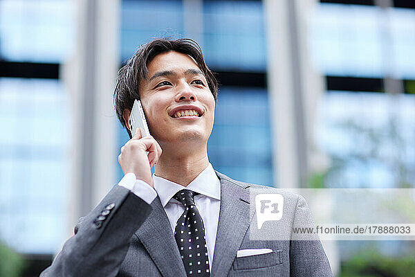Japanese businessman on the phone at business district