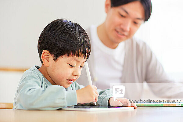 Japanese kid and father studying at home