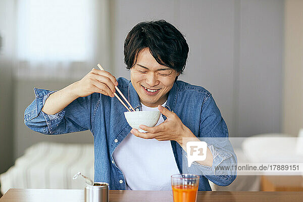 Japanese man eating at home