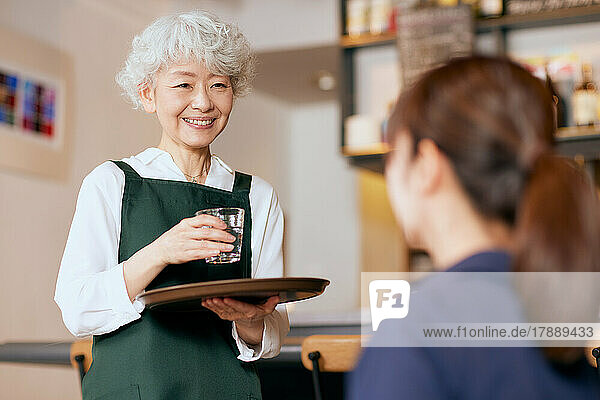 Japanese senior woman working at a restaurant