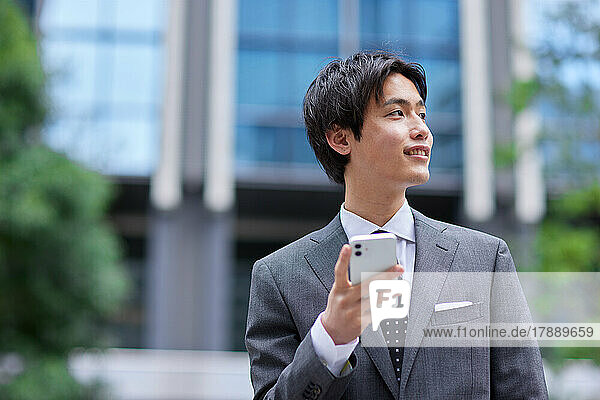 Japanese businessman on the phone at business district