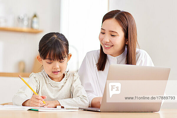 Japanese kid and mother studying at home