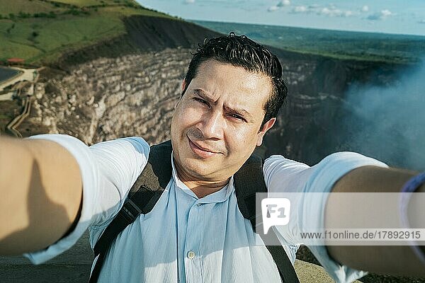 Adventurous people taking a selfie at a viewpoint. Close up of person taking an adventure selfie  Tourist taking a selfie at a viewpoint. Handsome tourist taking a selfie on vacation