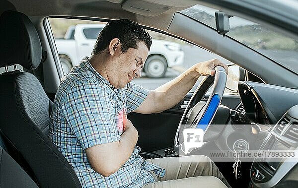 Person with heart attack while driving. Driver with chest pain. Driver's Heart Attack Concept  Suffering driver with chest pain  Male driver with chest pain in traffic