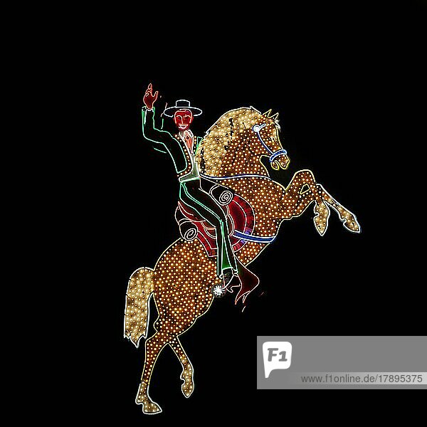 Bunte Leuchtreklame  Neonlichter in der Nacht formen Pferd und Reiternischer Reiter winkt  Pferd steigt  Bokeh  Fremont Street  Las Vegas  Nevada  USA  Nordamerika