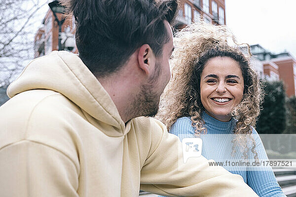 Happy young woman talking with boyfriend