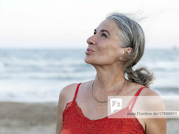 Retired senior woman with gray hair at beach