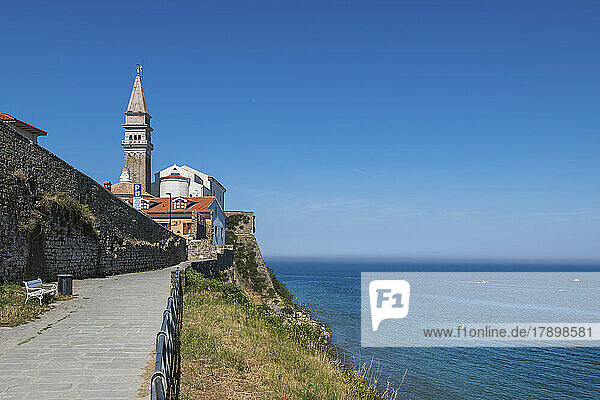 Slovenia  Piran  Seaside promenade with bell tower of Saint George Church in background