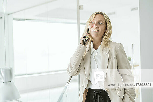 Smiling businesswoman on the phone in office