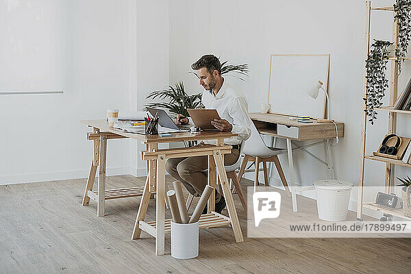 Mature architect working at desk in office