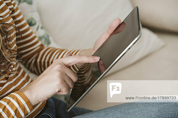 Close-up of woman using digital tablet
