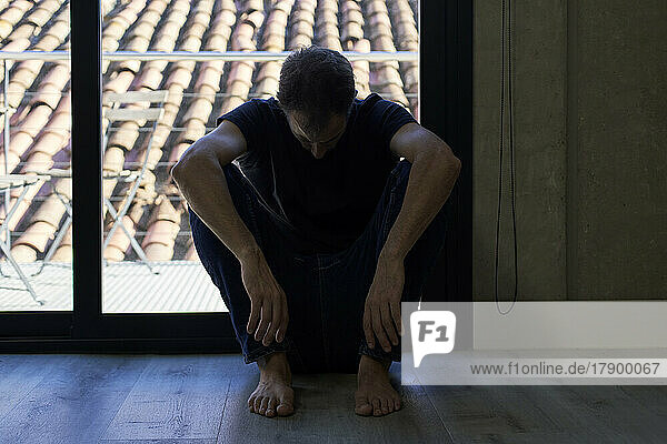 Man sitting in front of window