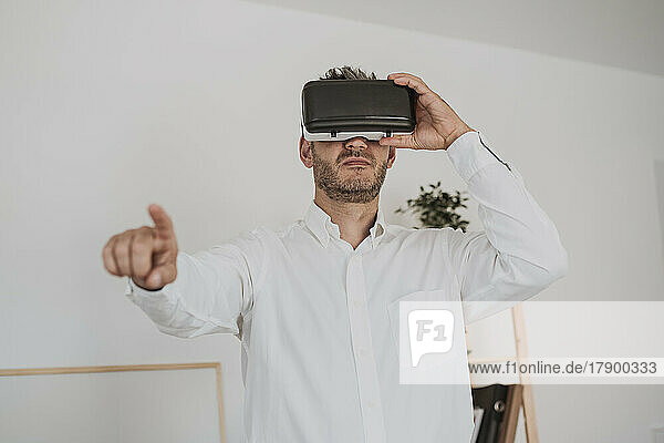 Businessman wearing virtual reality simulator in office