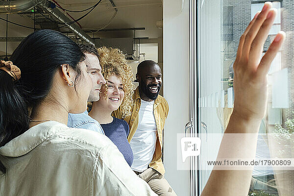 Group of business people looking out of window