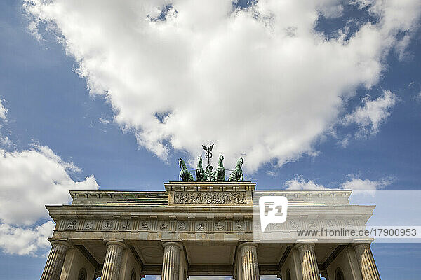 Brandenburg Gate under cloudy sky on sunny day at Berlin  Germany