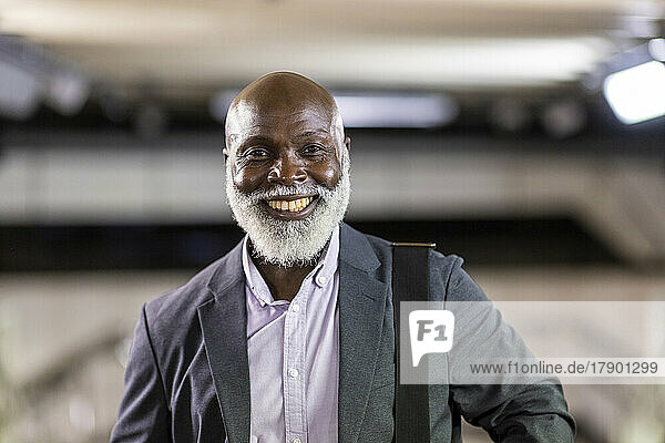 Smiling bald senior businessman wearing suit