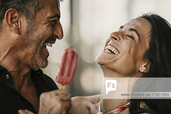 Fröhliches Paar genießt gemeinsam Eis
