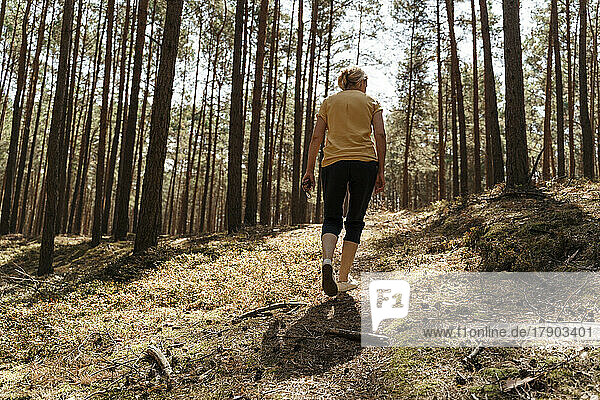 Mature woman hiking in forest