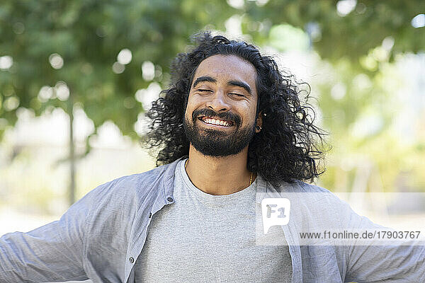 Happy bearded young man with long hair