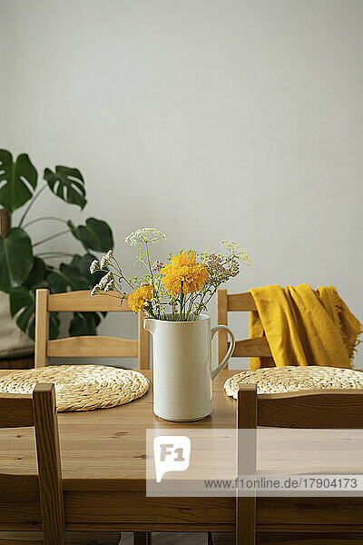 Flower vase on dining table at home