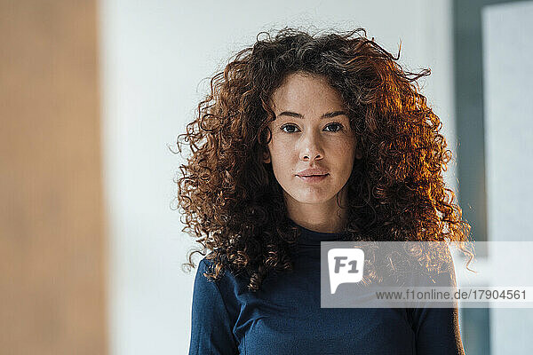 Beautiful young woman with curly hair